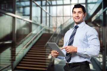 Smiling professional business man standing in office