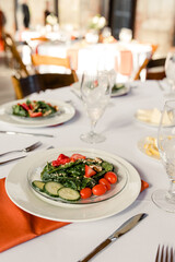 Salad plate with strawberries, cucumbers, tomatoes on table setting

