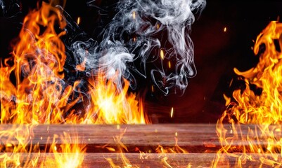 Wooden table with bright fire sparks and smoke