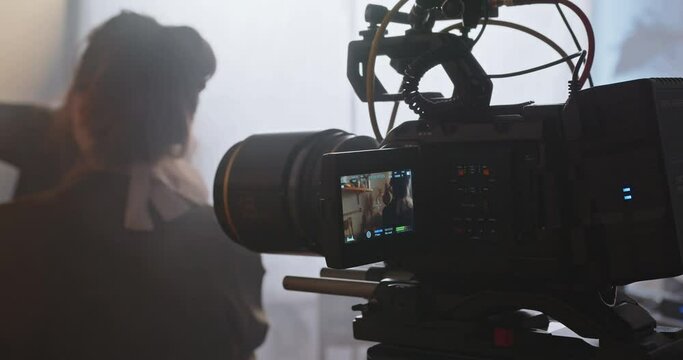 The cameraman with a professional movie camera at work.