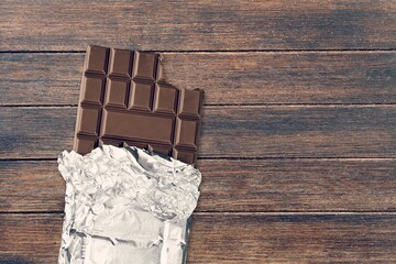 Bitten tasty sweet milk chocolate rapped in foil