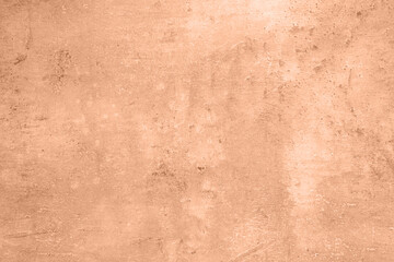 Stone surface of peach fuzz color, top view. Trendy shade of 2024 year