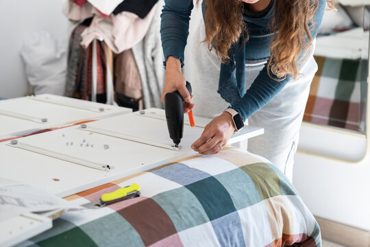 Woman assembling furniture