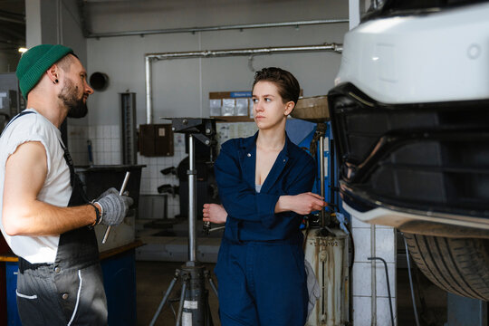 A group of people working in an auto repair shop