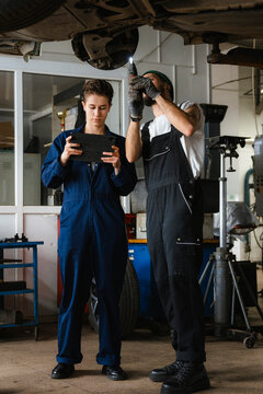 A group of people working in an auto repair shop