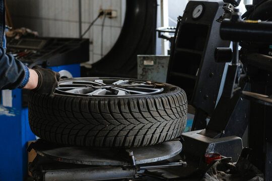 A man changes a wheel in a car