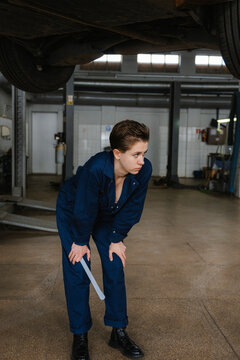 A woman is working in an auto repair shop