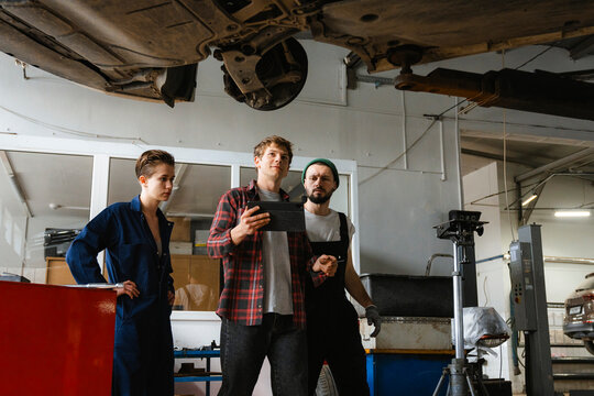 A group of people working in an auto repair shop
