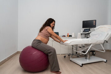 Pregnant woman working on exercise ball