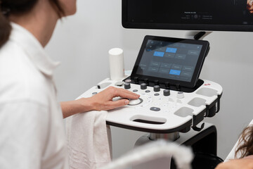 Technician operating ultrasound machine in clinic