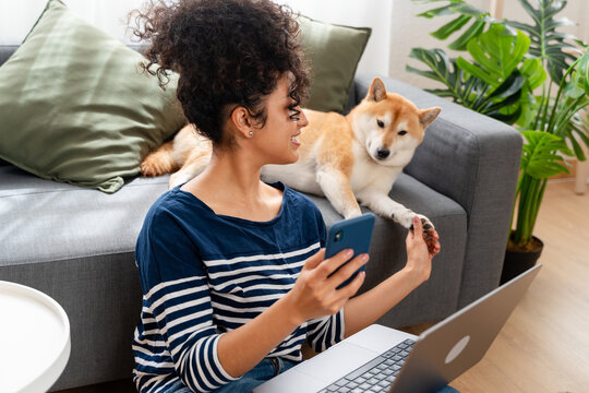 woman enjoying time with her shiba inu dog at home