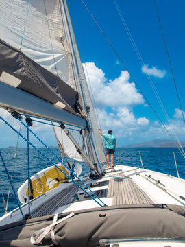 Man On Luxury Cruising Sailboat on Caribbean Island Vacation