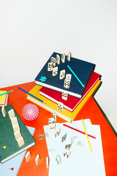 Curvy playful tactic row of dominos in office desk and hard flashlight