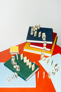 Curvy playful tactic row of dominos in office desk and hard flashlight