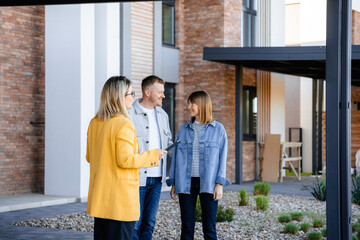 The real estate agent talks to the buyers