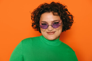 Stylish woman in green turtleneck and purple sunglasses