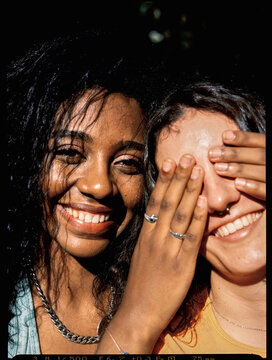 Portra 400 scanned image of a woman blindfolding her girlfriend