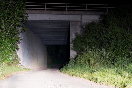Under a bridge in the countryside at night