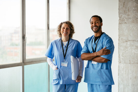 Confident doctors looking at camera at hospital