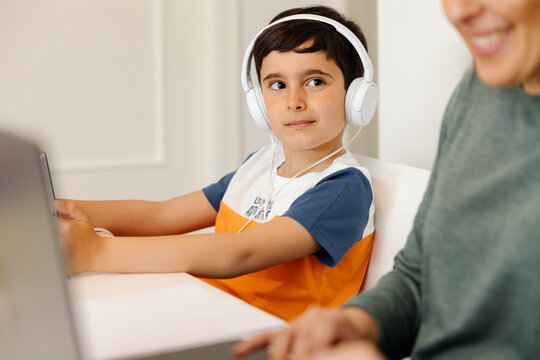 Young boy wearing headphones during an online class