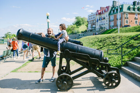 Kid on top of an ancient cannon in Quebec City
