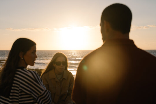 Three friends enjoys quality time together relaxing on the malecon