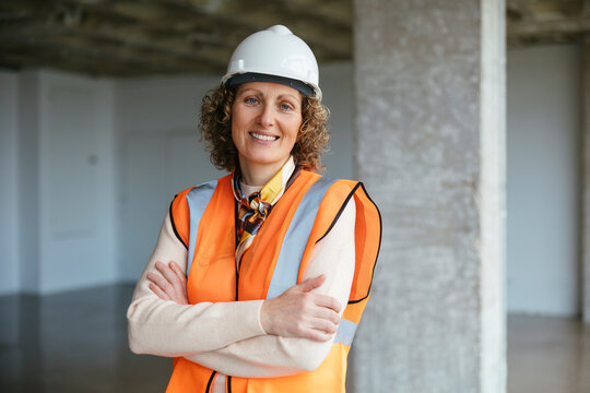 Confident builder in helmet looking at camera