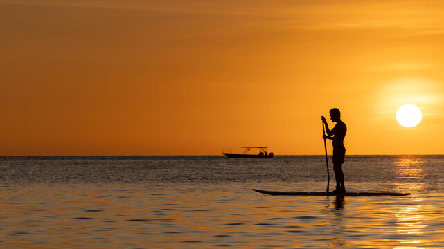 Sunset over Boracay with Silhouette of a SUP 