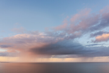 Storm clouds and rain over the open ocean. Sky with copy space.
