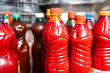 Red bottles of palm oil on shelf