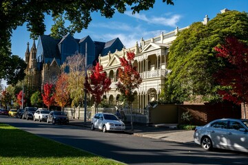 cars parked on a street near tall buildings in the background