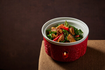 traditional chinese wok fried fat meat pork ribs chicken vegetable in spicy pepper and sweet sauce in bowl on stone table hotel cafe luxury halal food restaurant banquet menu
