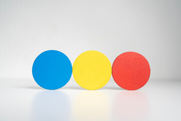 Three different colored balls are stacked on top of each other. The balls are blue, yellow, and red..