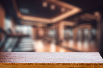 Empty wooden table top on Exercise room background