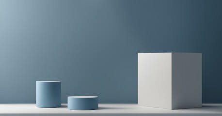 A minimalist arrangement of three geometric shapes on a flat surface against a gradient blue background. The shapes include a tall white rectangular prism and two blue cylinders of different heights.