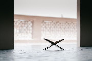 Islamic concept - The Holy Al Quran at beautiful mosque with written Arabic calligraphy meaning of...