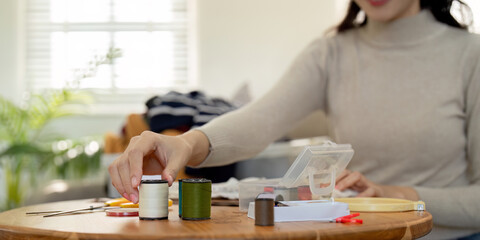 Volunteer Repair Clothes for Donation and Recycle, Promoting Sustainable Fashion and Community Support, Hands Working with Sewing Tools and Threads, Eco Friendly Initiative