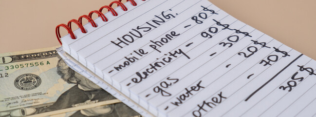 Counting expenses bills on housing electricity, gas, water. Banknotes of dollar cash around. High prices for energy inflation crisis. Cut back on spending. Savings rate © anna.stasiia