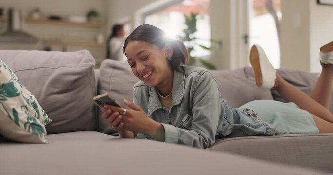 Phone, woman and text on sofa at home with social media, relax and website scroll on tech. Online, digital and internet video with a smile and happy from student and university break with mobile