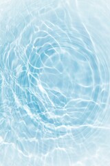 Blue water with ripples on the surface. Defocus blurred transparent blue colored clear calm water surface texture with splashes and bubbles. Water waves with shining pattern texture background.	