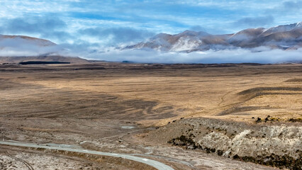 Drone  view of the Ashburton highlands with a river flowing through the dry arid terrain on the way to Lake Heron