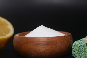 Baking soda and whole lemon on table 