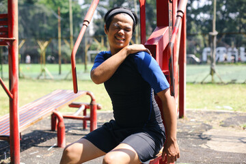 Obraz premium Young Asian Man In Sportswear Arm Injury Outdoor, Shoulder Pain. Healthcare And Medicine Concept