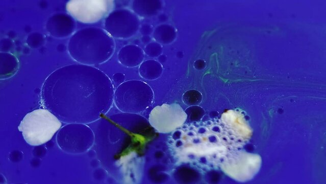 Aroma serum. Gel fluid. Defocused blue white green neon color natural blossom glitter texture mix stripe oil bubble circle abstract background.