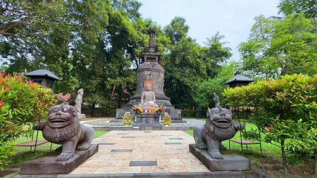 Buddha statue in Mendut monastery, dolly forward view