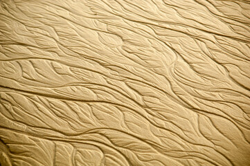 Intricate ripples, waves and patterns form in the sand as a texture