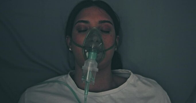 Hospital, emergency and woman on stretcher with mask, oxygen and transport to medical theater. Healthcare, crisis and patient on bed with ventilation, health insurance and trauma in ICU from above