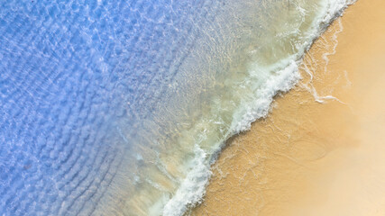 Top view beach sand background for summer vacation concept. Beach nature and summer seawater with sunlight light sandy beach Sparkling sea water 
