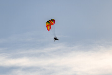 powered paraglider flying in the sky, summer adventure