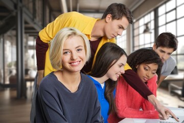 Happy international young students studying together